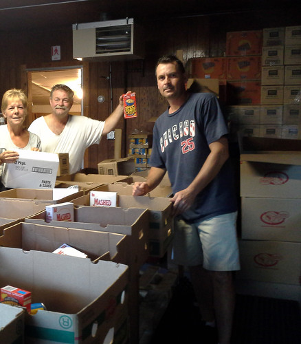 Bridgett, Barney, and Mark packing dry goods into  boxes