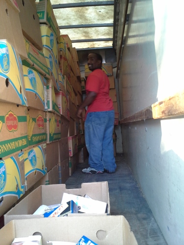 Janon stacking boxes of dry goods into truck