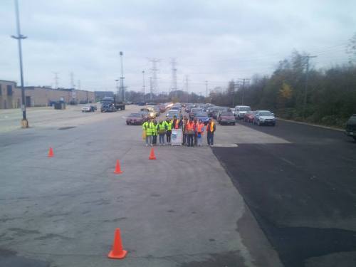 Volunteers at the beginning of Thursday morning distribution in front of car line up